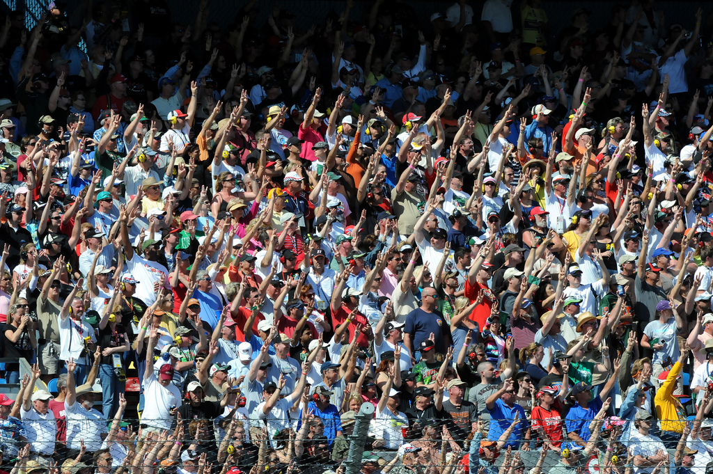 NASCAR fans hoist three fingers into the air during the third lap of the 53rd running of the Daytona 500 on Sunday to honor the late Dale Earnhardt, who was killed in a crash here 10 years ago while driving the No. 3 Goodwrench Chevrolet. U.S. Army photo by Tim Hipps, FMWRC Public Affairs